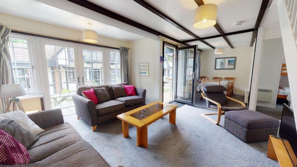 a living room with a couch and a table at 15 Tudor Court, Tolroy Manor in Hayle