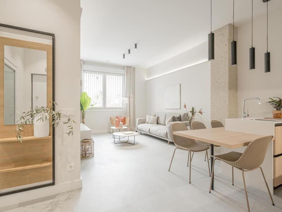 Il comprend une cuisine et un salon avec une table et des chaises. dans l'établissement Apartamentos Pamplona by Clabao, à Pampelune