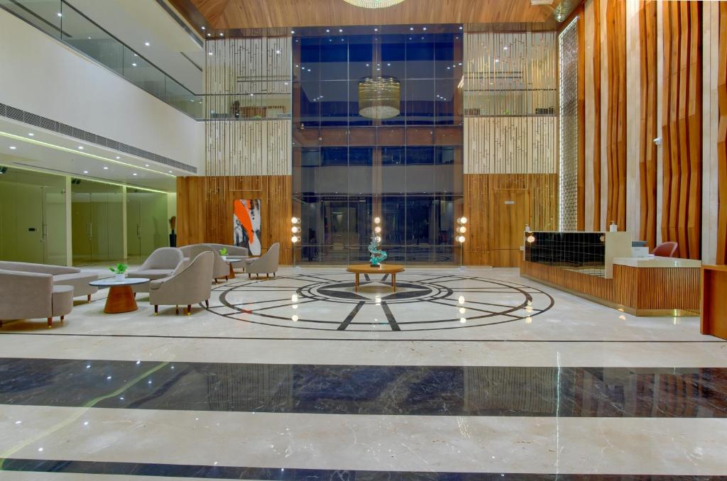 a lobby with a fountain in the middle of a building at Sayaji Morbi in Morbi