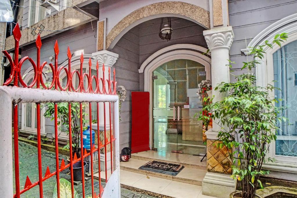 a red gate in front of a house at RedDoorz At Ralica Grand Palladium Medan in Medan