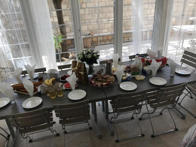 a dining room table with chairs and food on it at Apartments Zore Dubrovnik in Dubrovnik