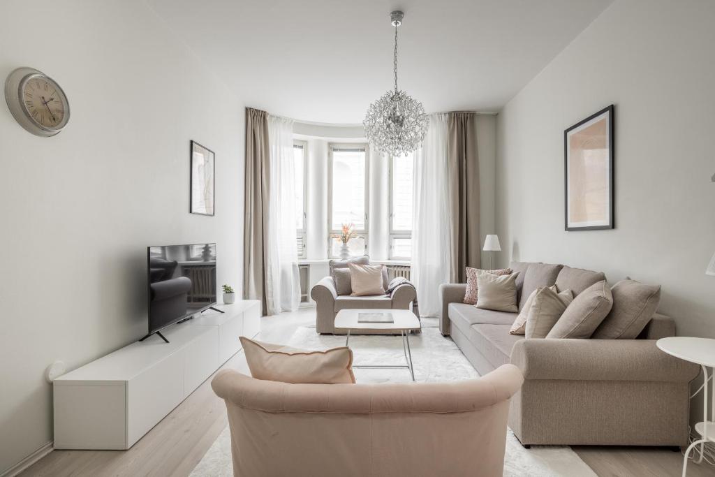 ein Wohnzimmer mit Sofa und Fernseher in der Unterkunft Comfortable city home in Helsinki