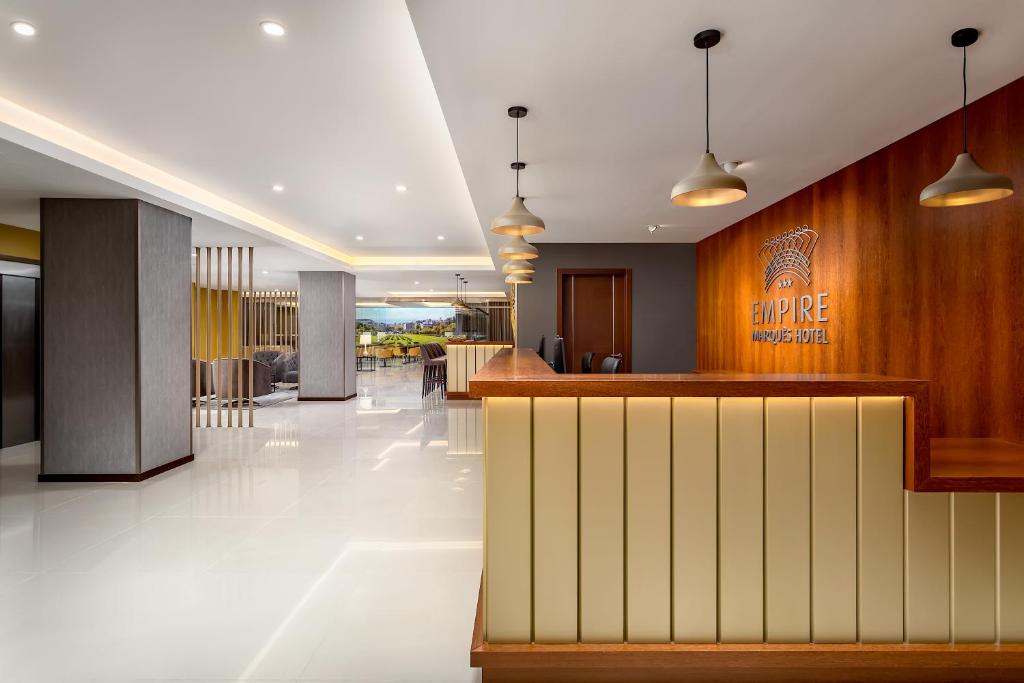 a lobby of a hotel with a bar in it at Empire Marquês Hotel in Lisbon