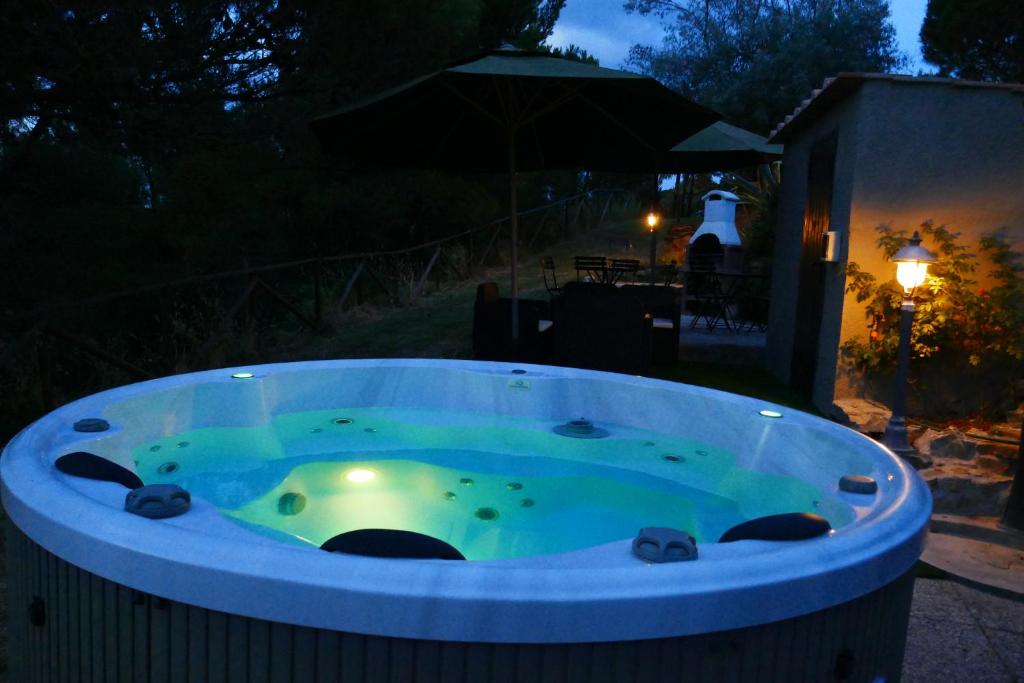 a jacuzzi tub in a yard at night at Arpaderba B&B in Livorno