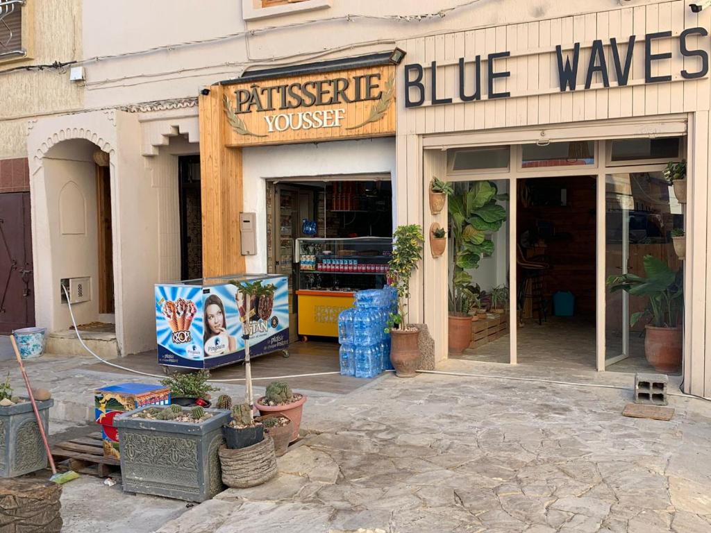 a store with a sign that reads blue waves at Appartement youssef in Agadir