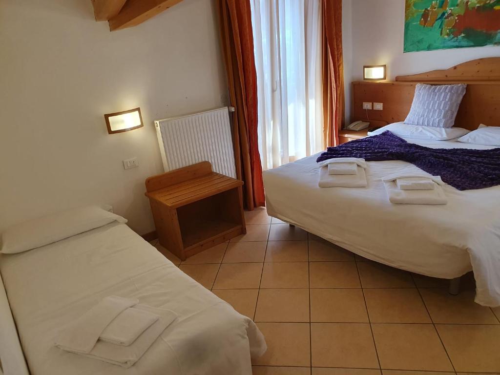 Postel nebo postele na pokoji v ubytování Hotel Andalo