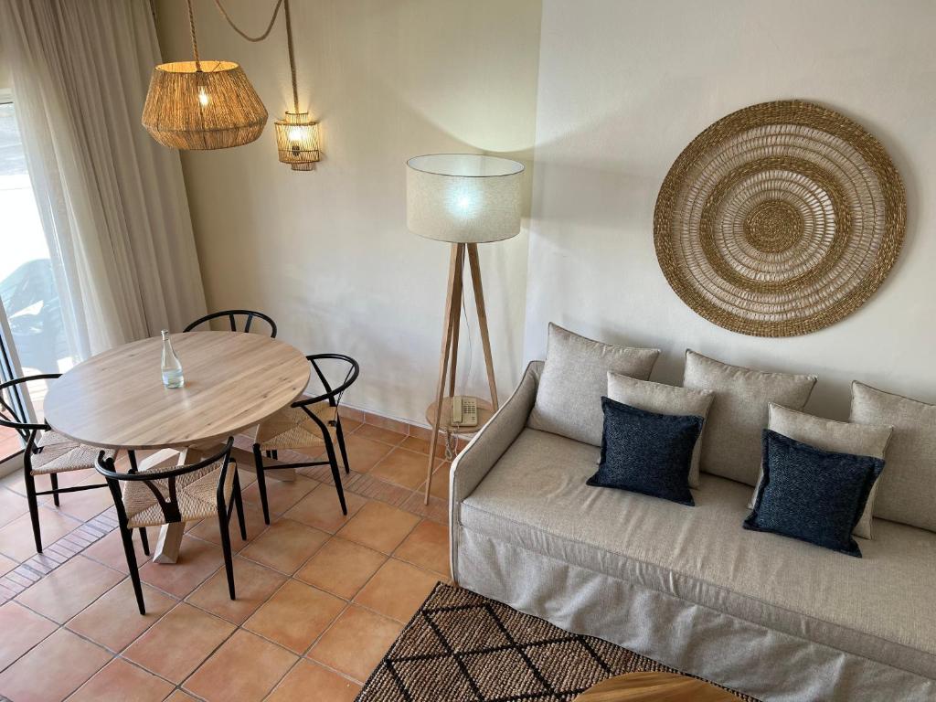 a living room with a couch and a table at Pestana Palm Gardens in Carvoeiro