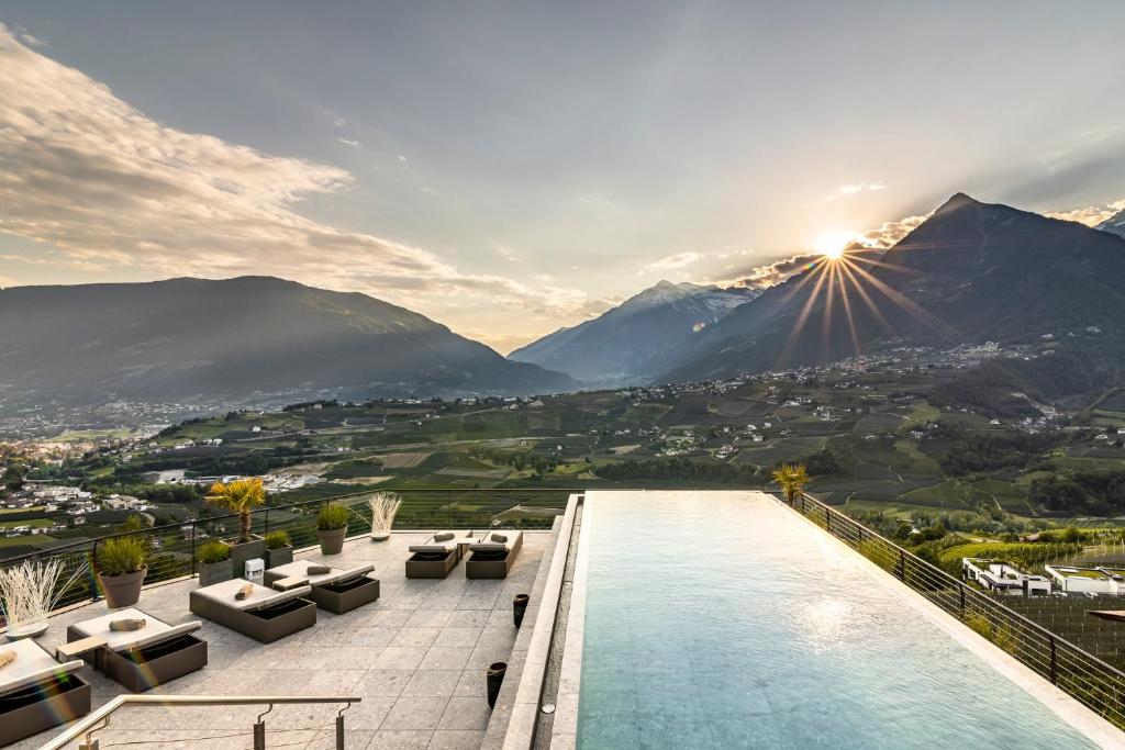 a swimming pool with a view of mountains at Prunner Luxury Suites - Adults Only in Schenna