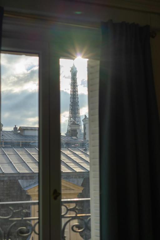 a view of the eiffel tower from a window at Eiffel Tower view Residence in Paris