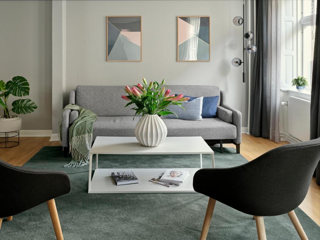a living room with a couch and a table at Rosenborg Hotel Apartments in Copenhagen