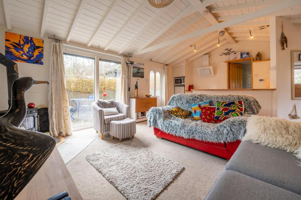 a bedroom with a bed and a couch in a room at The Tao House in Sheringham