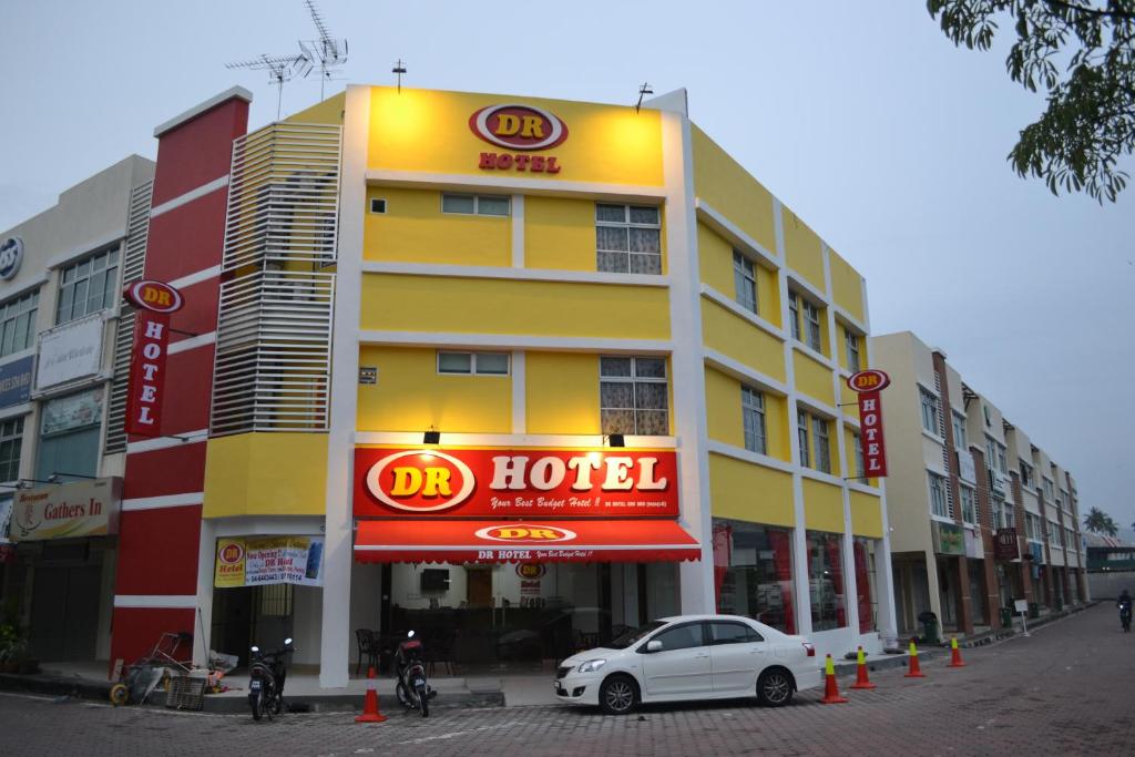 a hotel with a car parked in front of it at DR Hotel Penang in Bayan Lepas