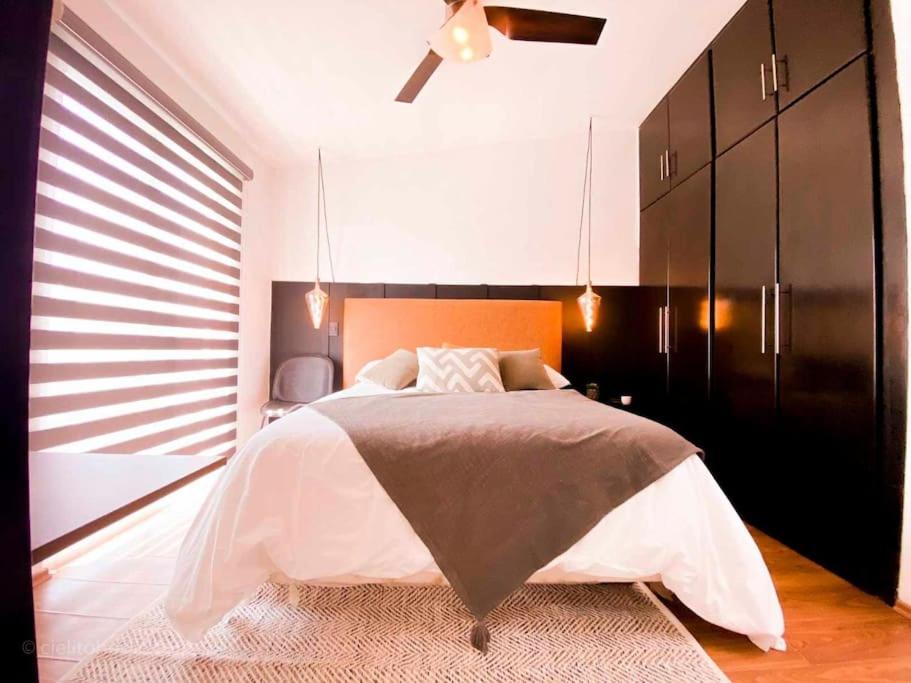 a bedroom with a large bed and a black cabinet at Cielito Home in Jesús María