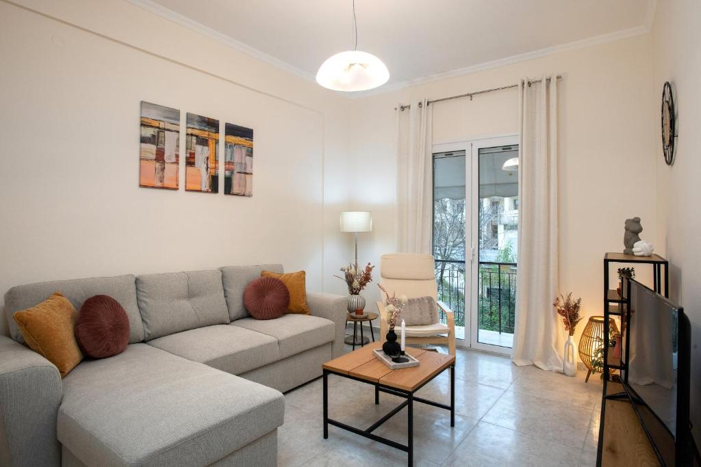 a living room with a couch and a tv at Helena's Apartment in Corfu town in Corfu