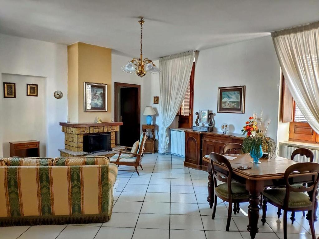a living room with a table and a fireplace at Appartamento Dimora dei marchi in Cosenza