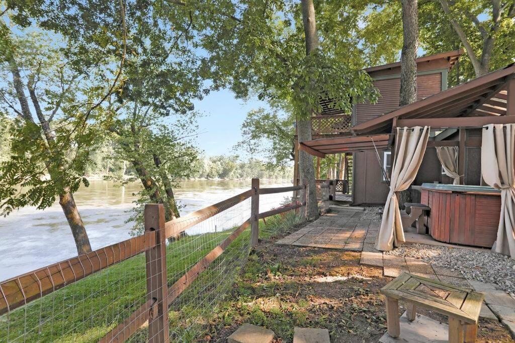 a fence next to a house with a fence at Waterfront Cabin overlooking Potomac w/ Hot tub 