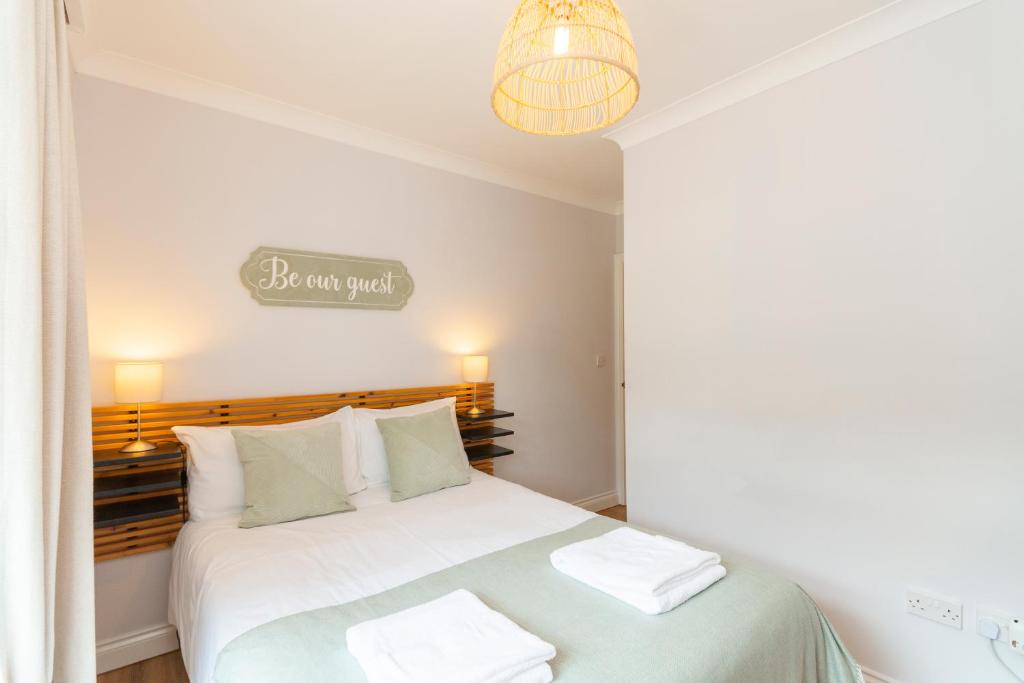a bedroom with a white bed with white pillows at The Peak by Afan Valley Escapes in Cymmer