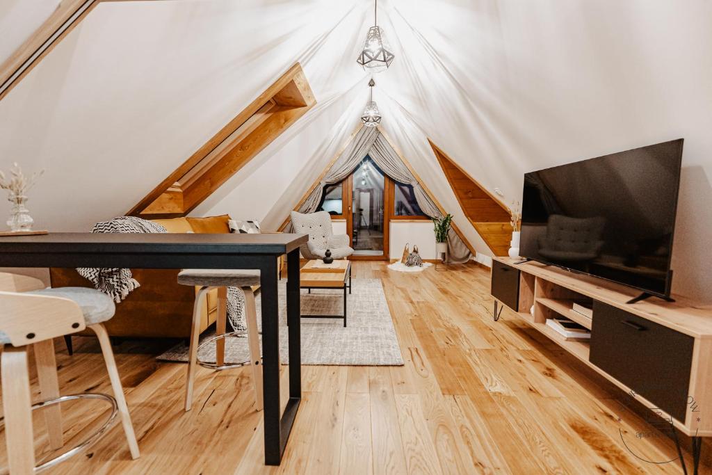 a living room with a tent with a television and a table at Apartamenty Schronisko Snów in Bukowina Tatrzańska