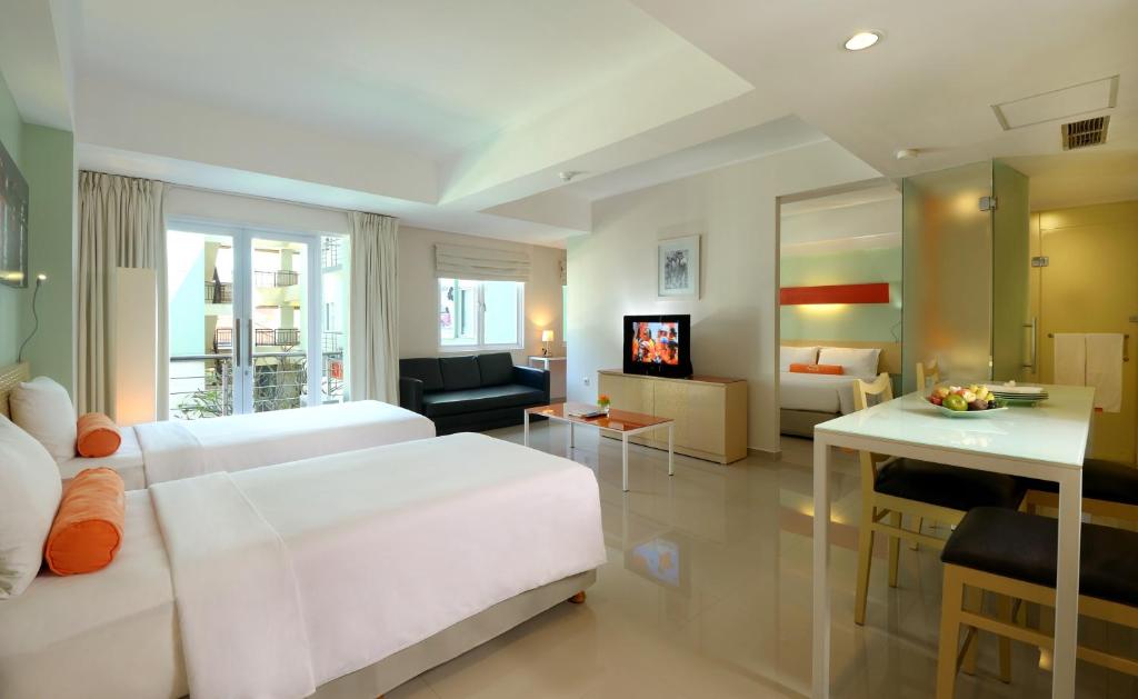 Postel nebo postele na pokoji v ubytování HARRIS Hotel & Residences Riverview Kuta, Bali