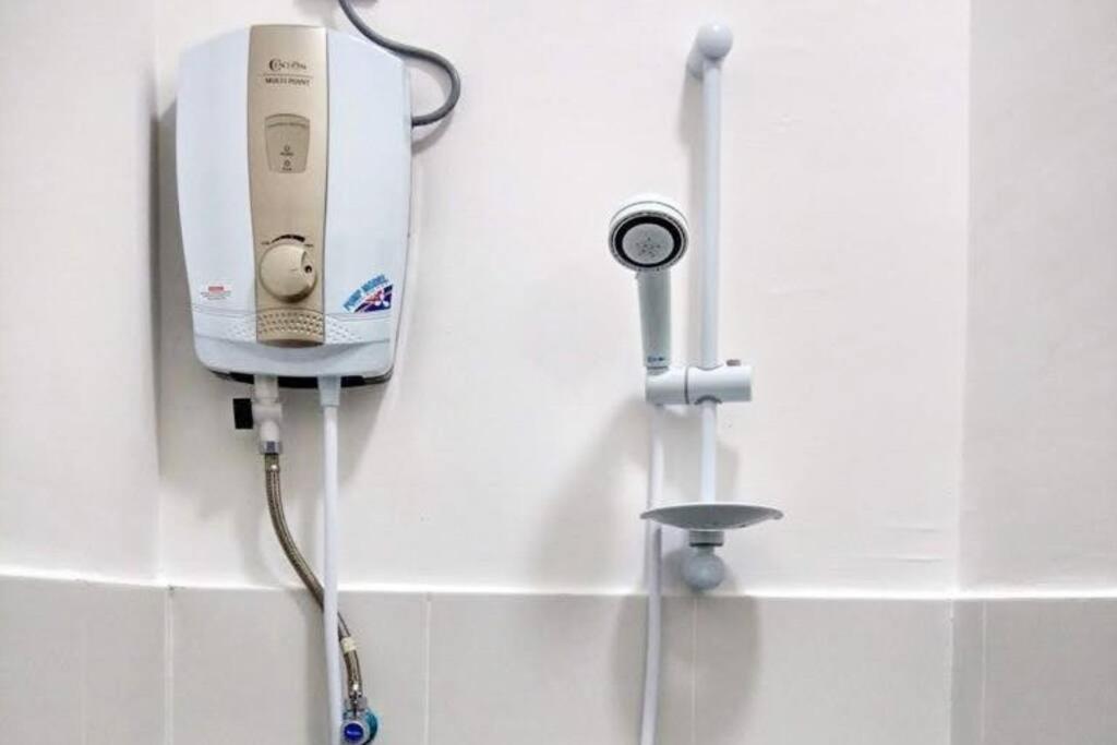 a soap dispenser on a wall in a bathroom at Cameron Hill Homestay in Tanah Rata