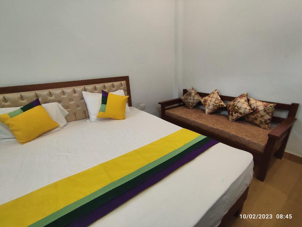Hotel StudioZ Sahastradhara في دهرادون: سريرين مع وسائد ملونة عليهم في غرفة