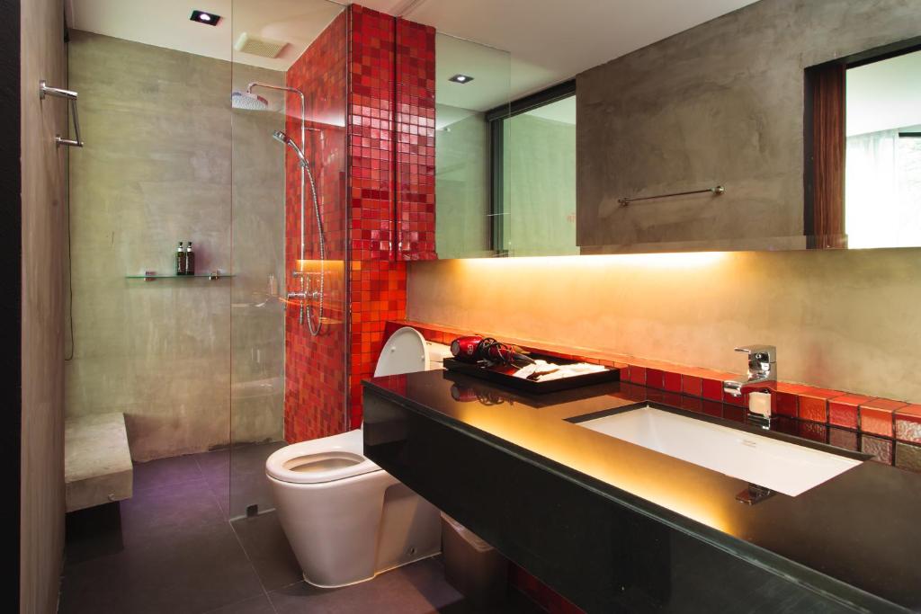 a bathroom with a toilet and a sink and a shower at Stellars Samed Resort in Ko Samed