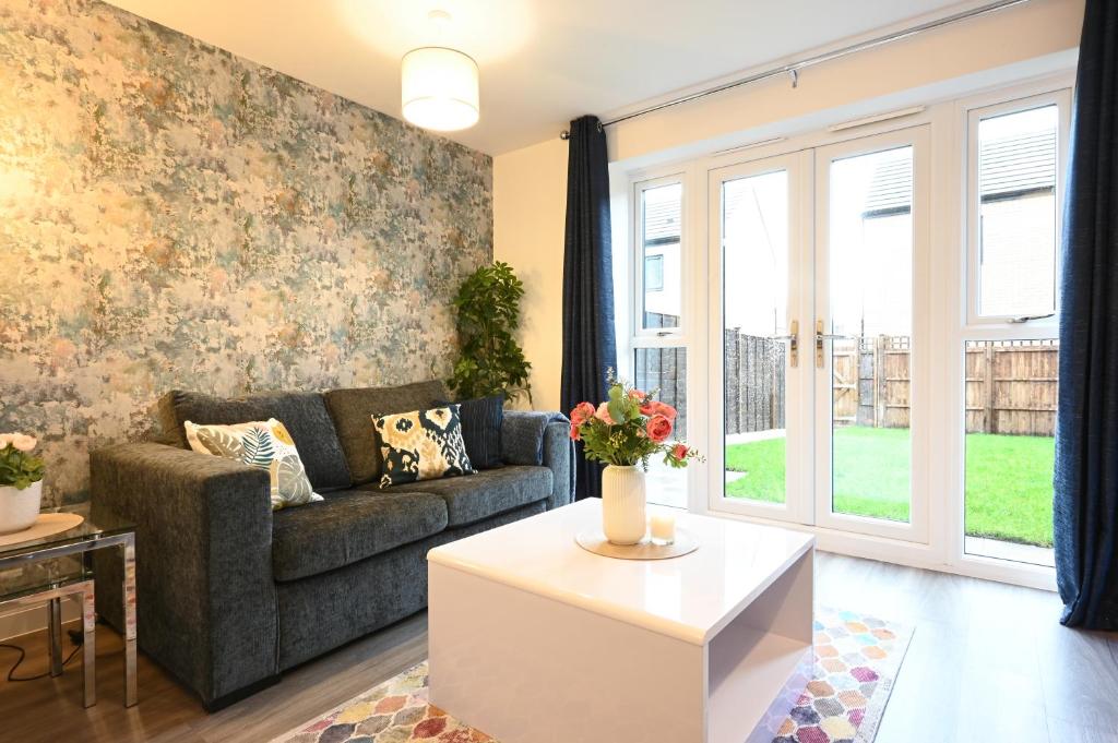 a living room with a couch and a table at Luxury 4 Bed House with Gated Parking in the Heart of Birmingham! in Birmingham
