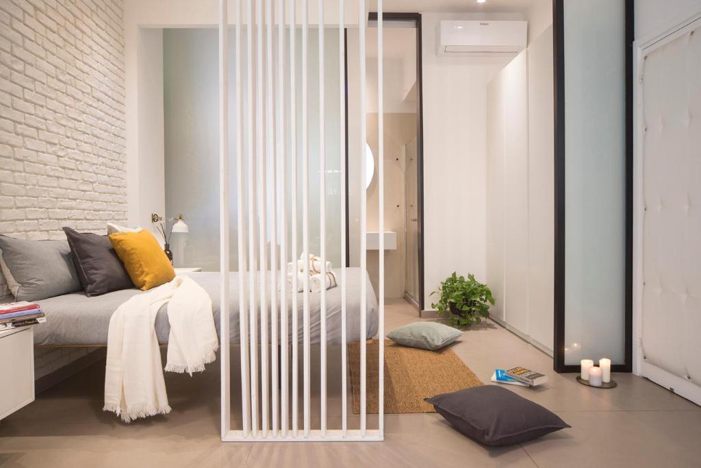 salon z łóżkiem i szklaną ścianą w obiekcie Stay In Ortigia w Syrakuzach