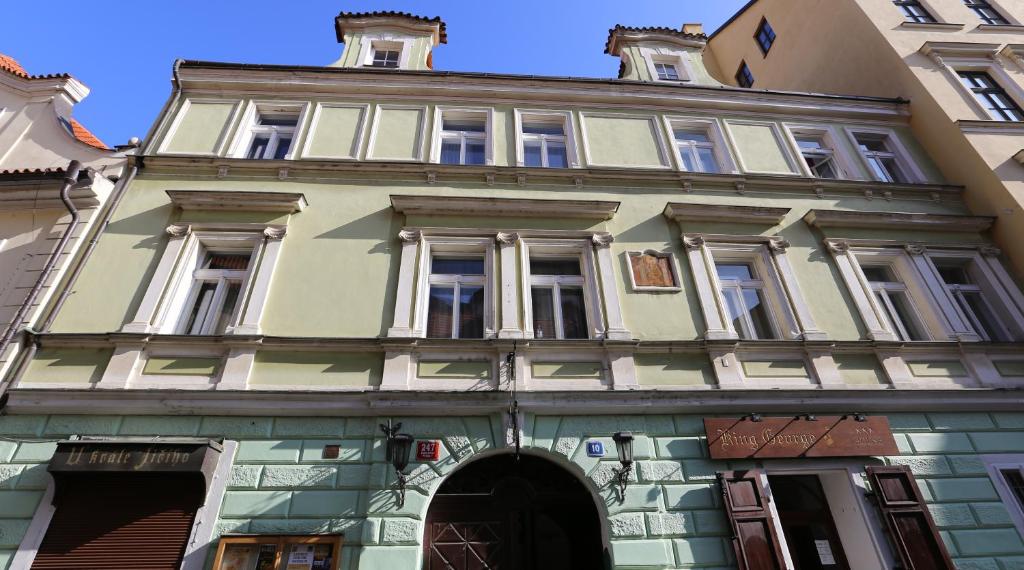 a large building with an archway in front of it at Hotel King George in Prague