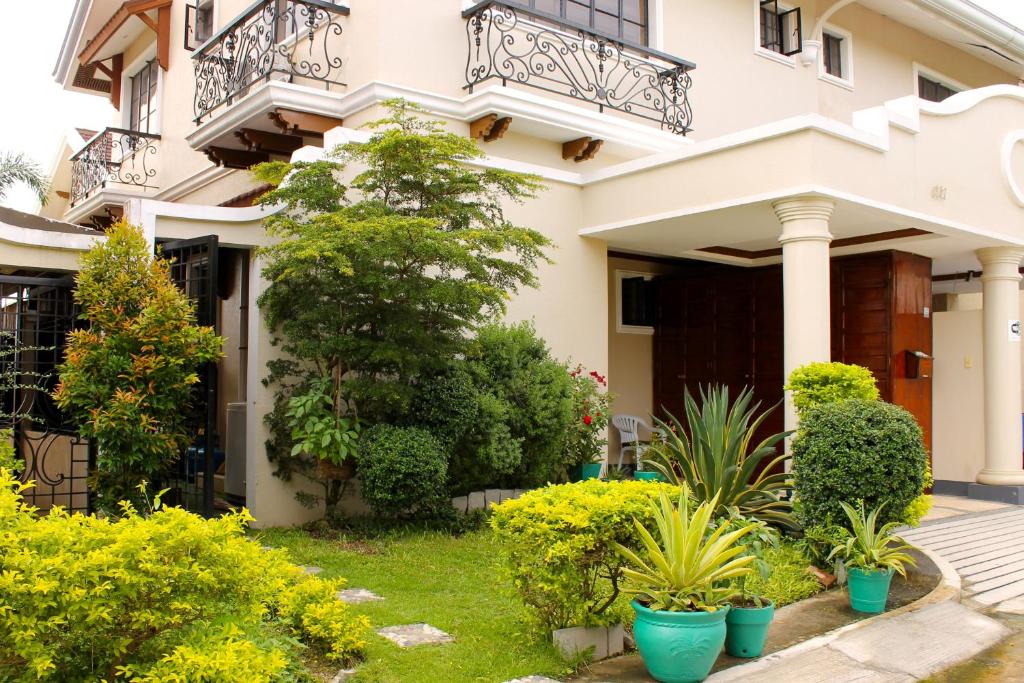 a house with plants in front of it at Eagle Ridge Family Vacation House in General Trias