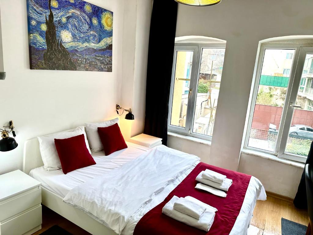 a bedroom with a bed with red and white pillows at Aram Galata Suites in Istanbul