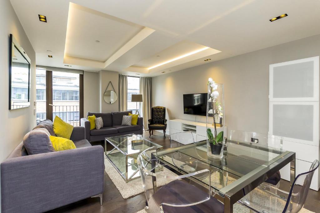 a living room with a couch and a glass table at New Build-Air Con-2 Bedroom-Two Bathrooms Apt 2 in London