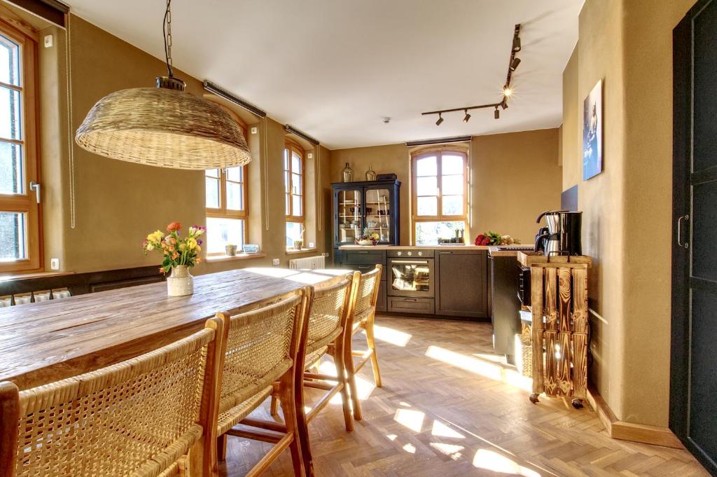 a kitchen with a large wooden table and chairs at Erzgebirge Suite Altes Rathaus in Cranzahl