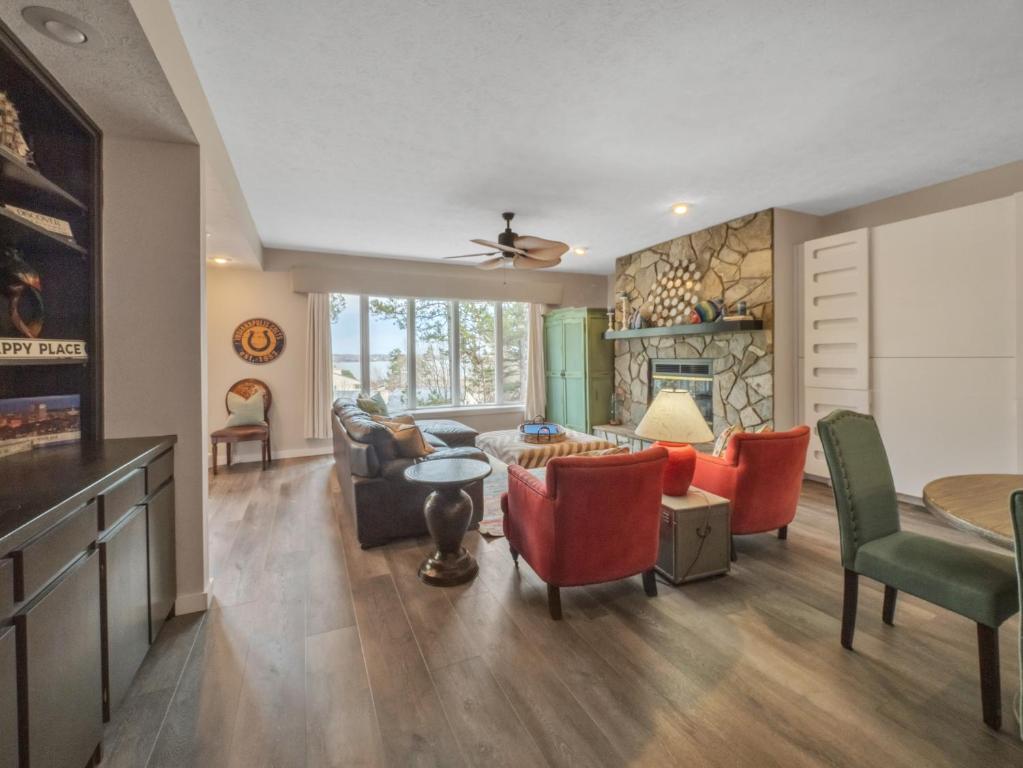 a living room filled with furniture and a fireplace at Lake front Keowee Condo with Balcony & Resort Amenities! 20 min to Clemson condo in Salem