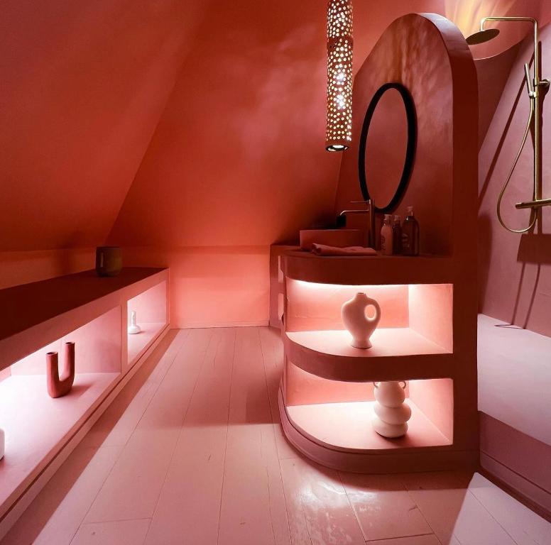 a bathroom with a vanity with a mirror and a sink at Suite La Bonita 
