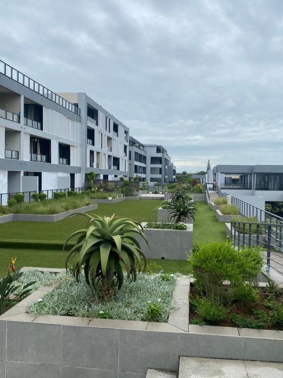 an apartment complex with a courtyard with palm trees at 608 Beacon Rock in Durban