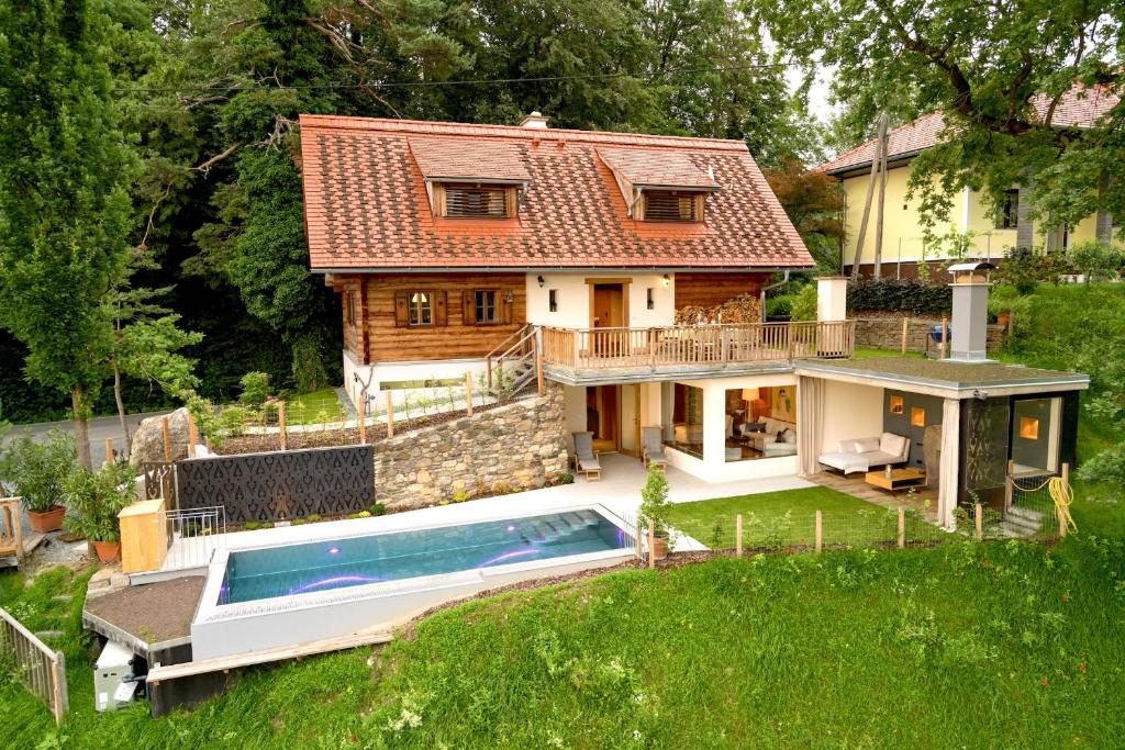 a house with a swimming pool in front of it at Thombauer Hube in Sankt Johann im Saggautal