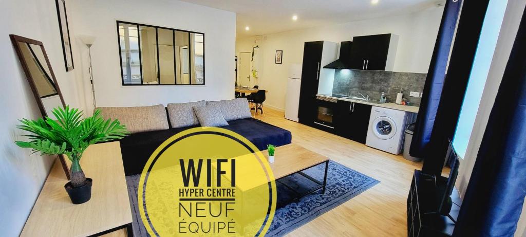 a living room with a couch and a table in a living room at Le Wlérick 4 - Hyper centre - Au calme - Wifi in Mont-de-Marsan