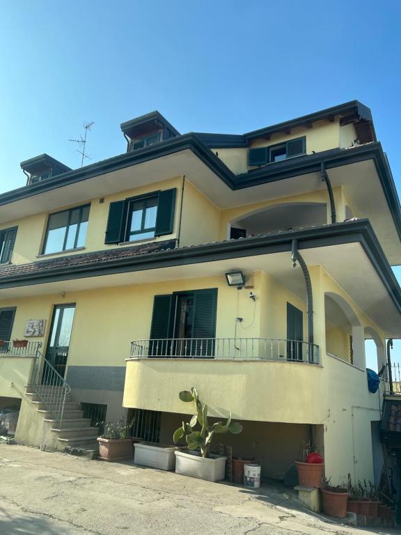 a large yellow building with stairs and windows at Affittacamere Karma in Rho