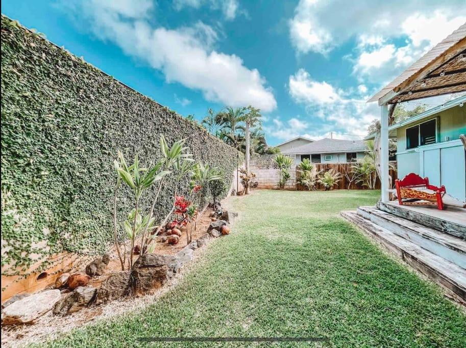 un patio trasero de una casa con una pared de retención en ____Cute Plantation House in Kailua with AC!!_____ en Kailua