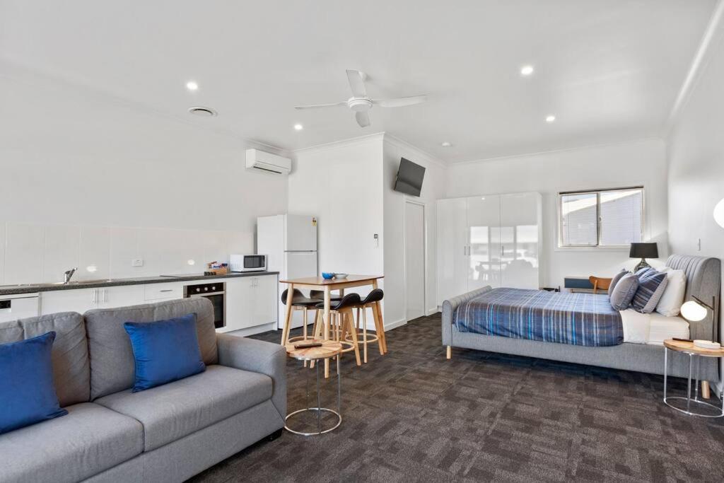 a living room with a couch and a bed at Port Lincoln Shark Apartment 4 in Port Lincoln