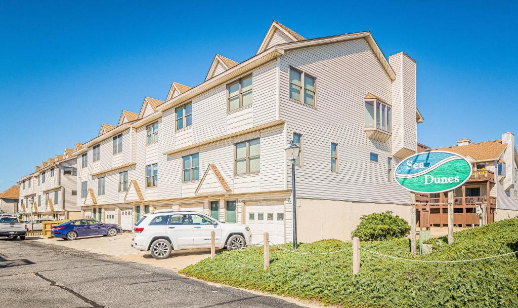 a large apartment building with a sign in front of it at OCTIPI Your SenSEAS in Kitty Hawk