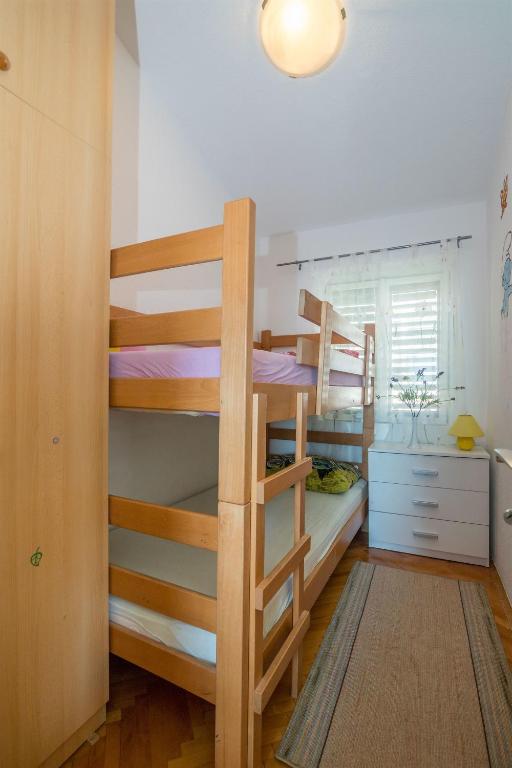 Postel nebo postele na pokoji v ubytování Apartments Tolj