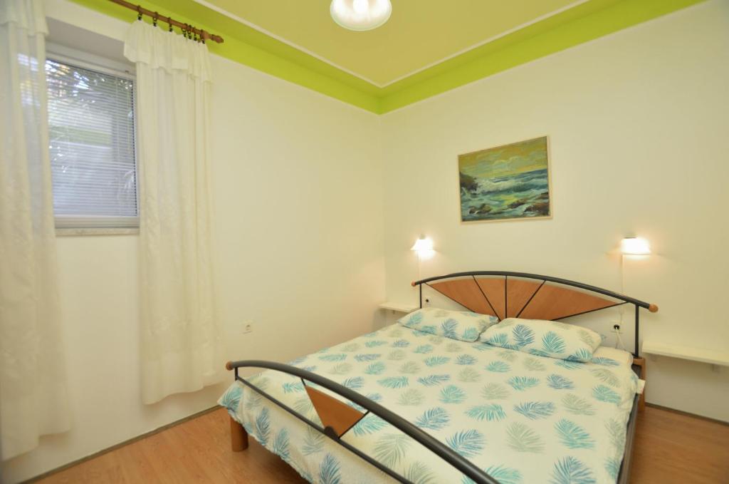 Postel nebo postele na pokoji v ubytování Apartments Romina