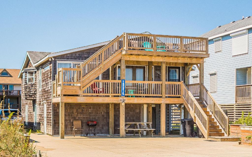 a large wooden house with a deck at The TARDIS in Kitty Hawk