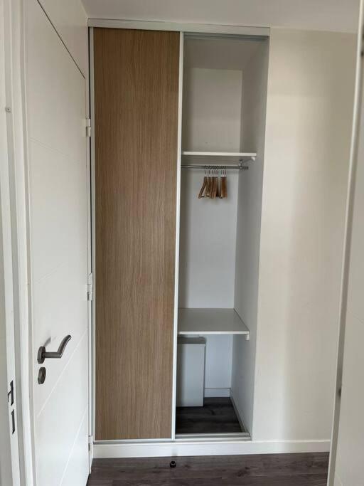 a closet with a mirror in a room at Appartement de Romainville in Romainville