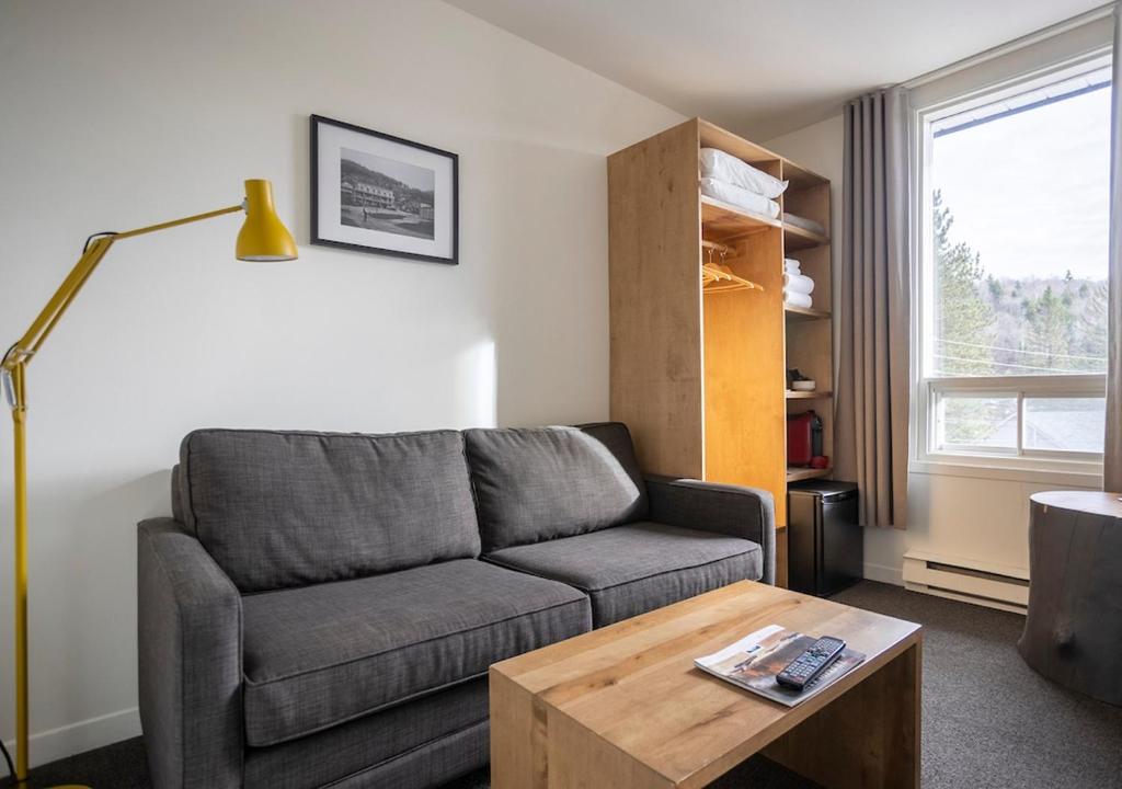 a living room with a couch and a coffee table at Hotel Mont-Tremblant in Mont-Tremblant