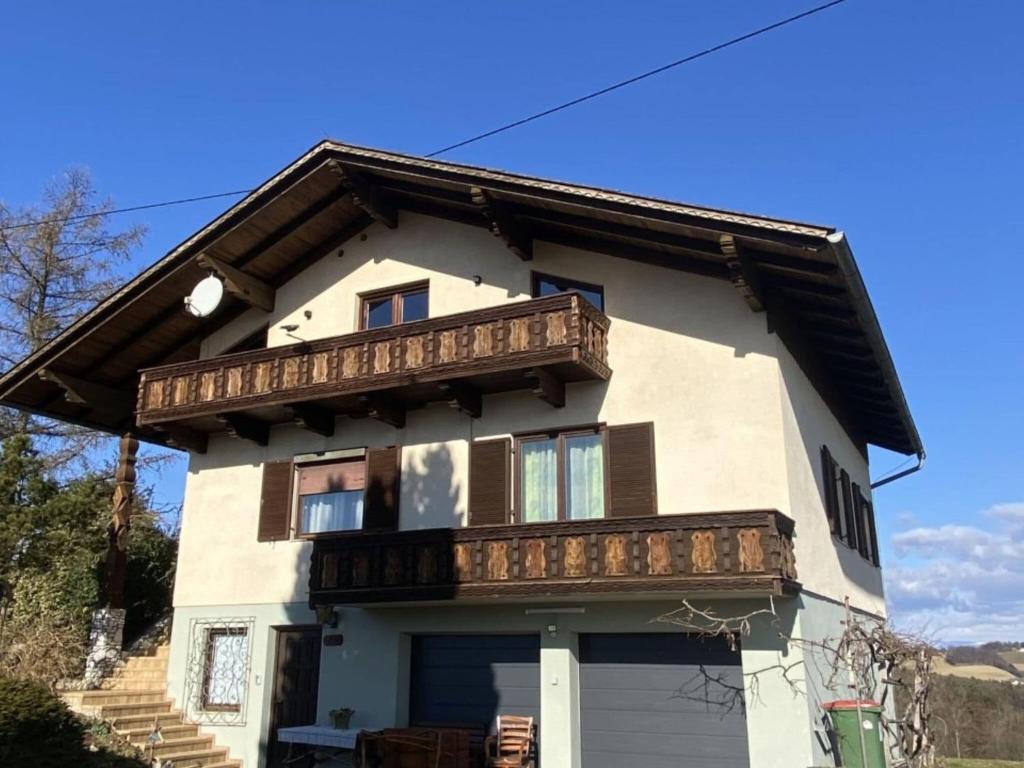 a house with a balcony on top of it at Cozy holiday home in Paldau in a charming area in Paldau