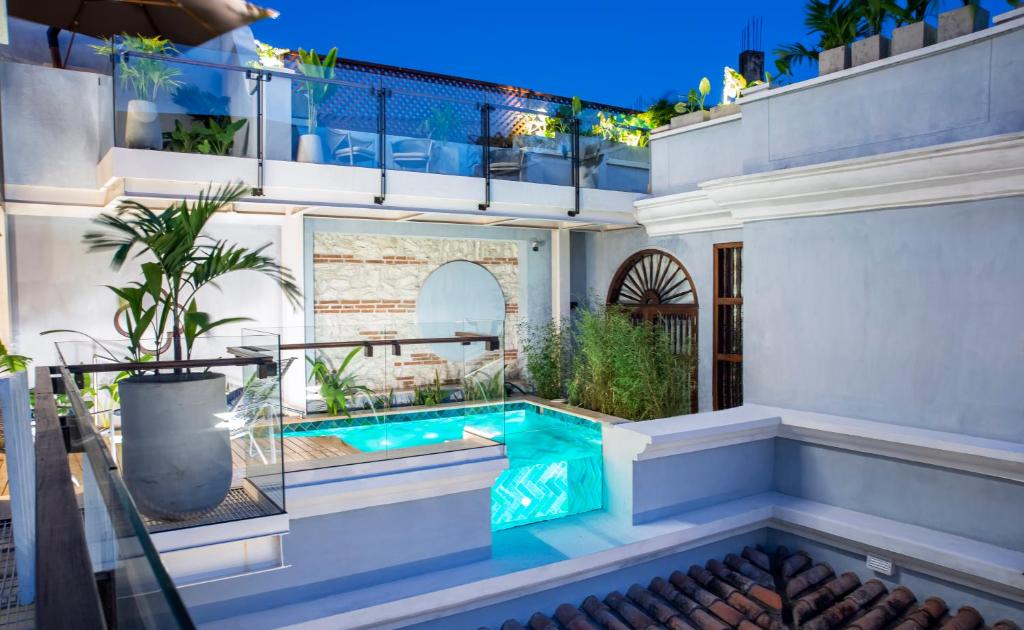 a house with a swimming pool in the backyard at Hotel Casona del Porvenir in Cartagena de Indias