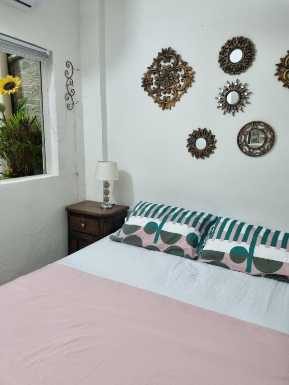 a bedroom with a bed and some wreaths on the wall at Casa Rebecca 39-41 in Cartagena de Indias